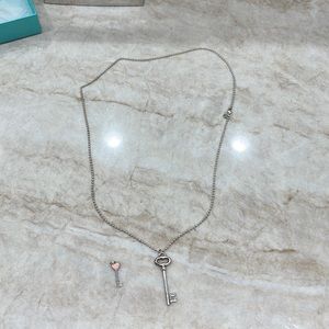 Tiffany and Co long key necklace with smaller key charm.